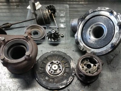 разобранная грязная турбина на верстаке